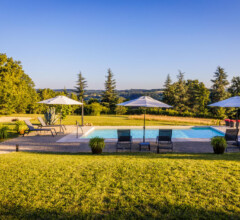 Golden hour glow over the pool and garden at luxury villa Bijou de Dordogne